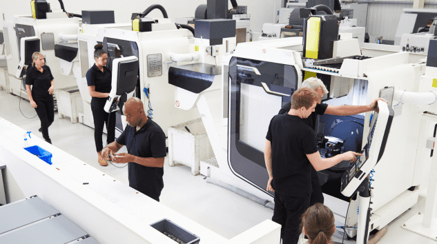 Overhead view of Engineering Workshop with workers using CNC machinery.