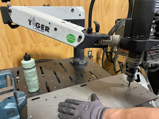 Roscamat Tiger is used to tap holes in a steel plate.