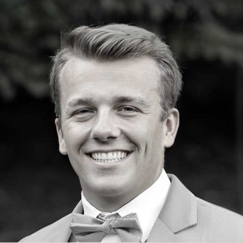 black and white image of man smiling at the camera